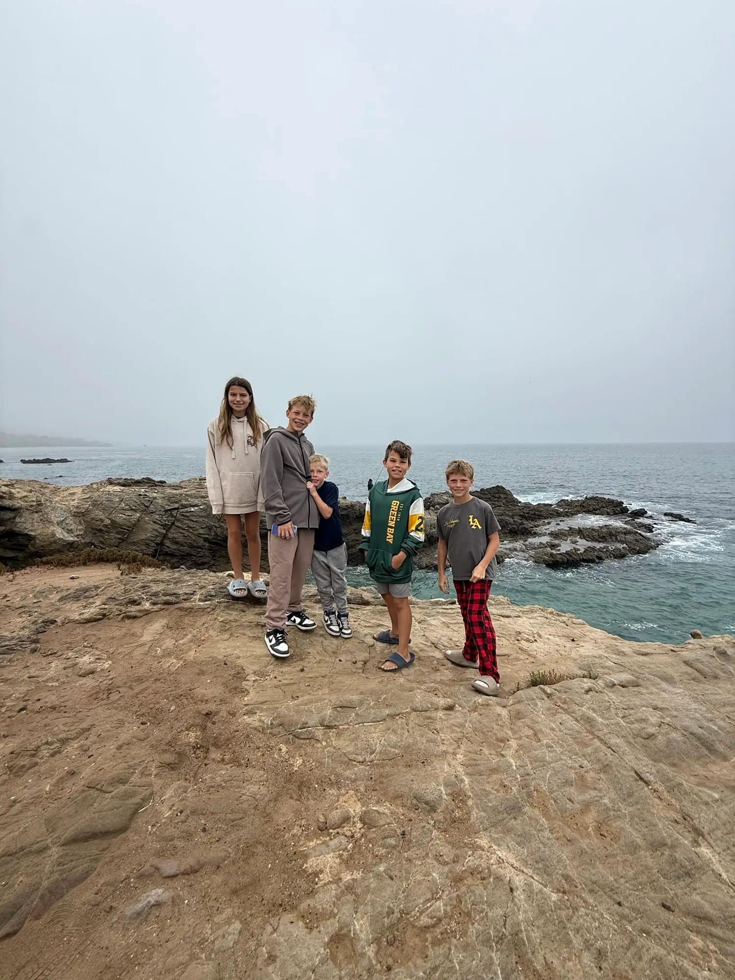 leo-carrillo-campground-1 Five children posing on a rocky cliff in Malibu, California overlooking the ocean on a foggy day