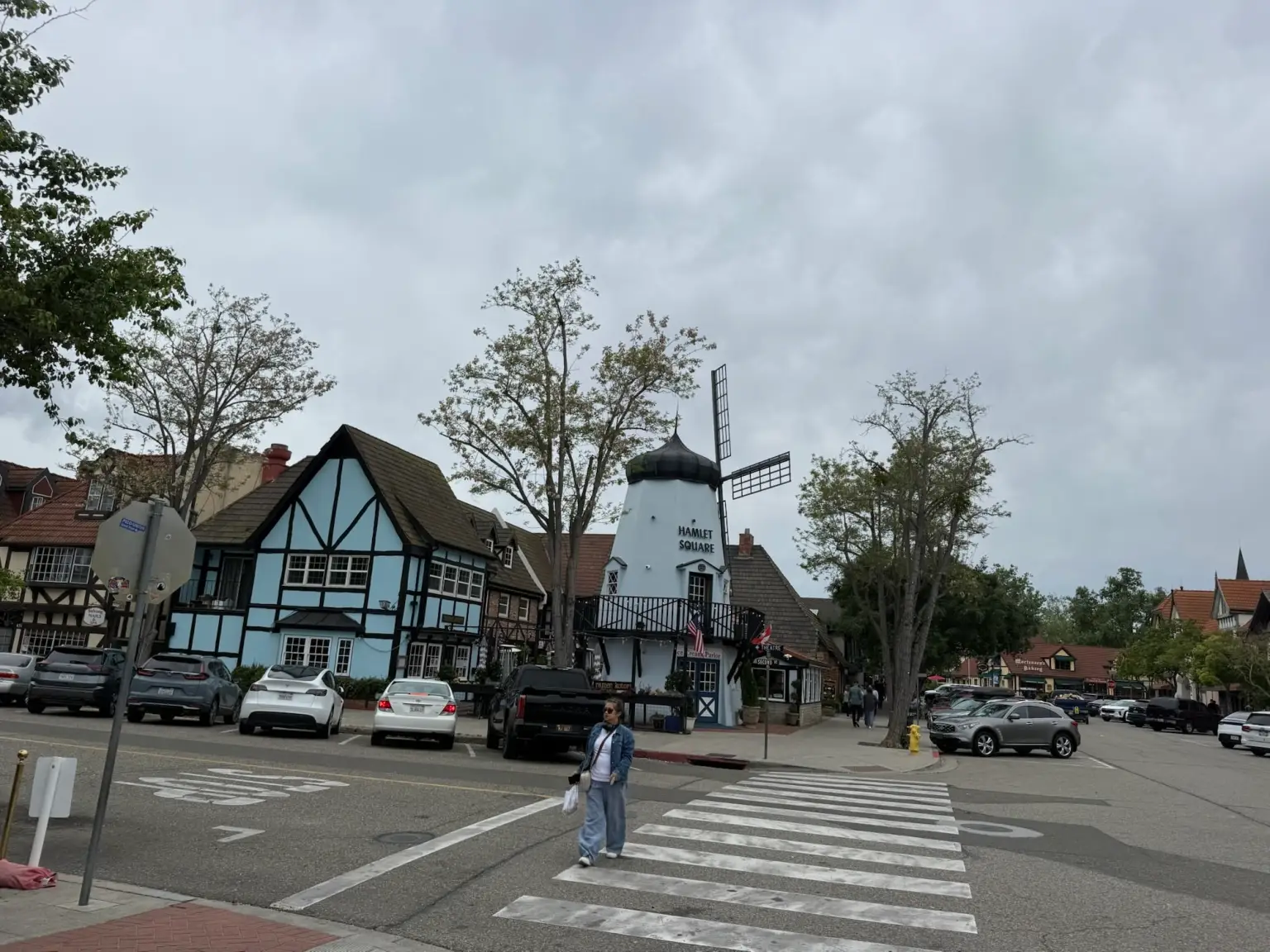img_3130 A street scene in a Danish-style village known as Solvang, Ca, featuring a windmill building labeled Hamlet Square.