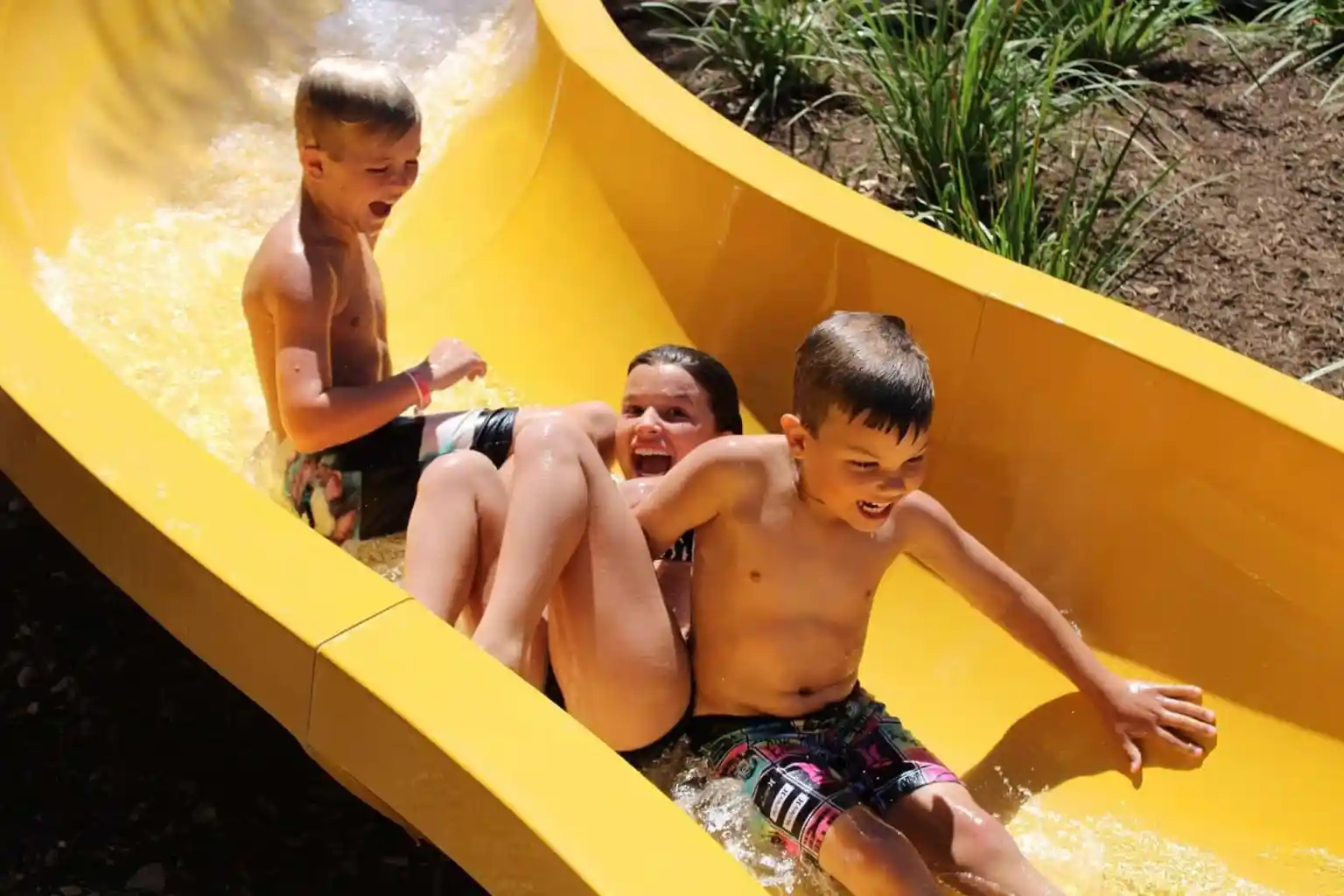 Kids laughing on a waterslide at one of the best water parks in America