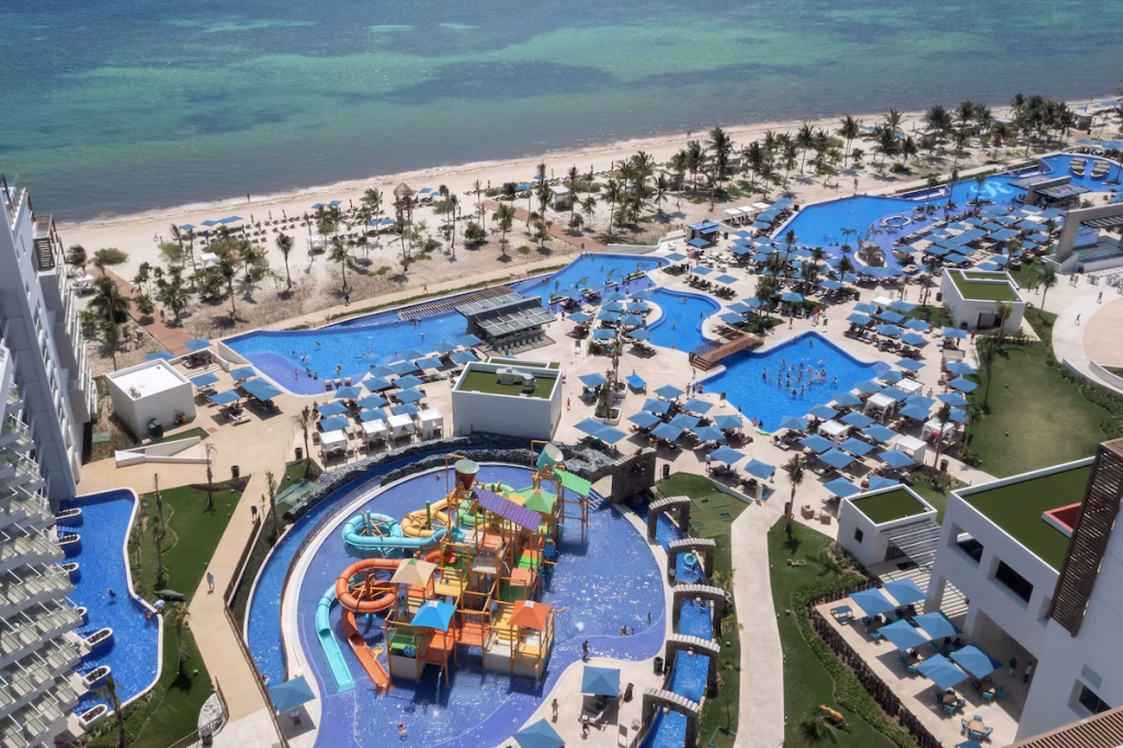 An aerial view showing multiple pools and waterslides at one of the Cancun resorts with waterparks