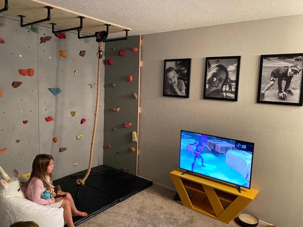 A kids rock climbing wall and entertainment area for the ultimate playroom decorating ideas.