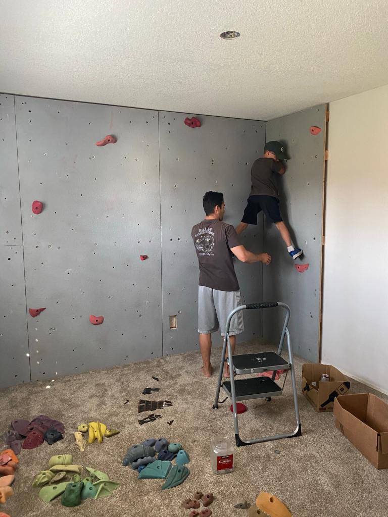 My husband built a kids rock climbing wall, which was high on my list of decorating playroom ideas.