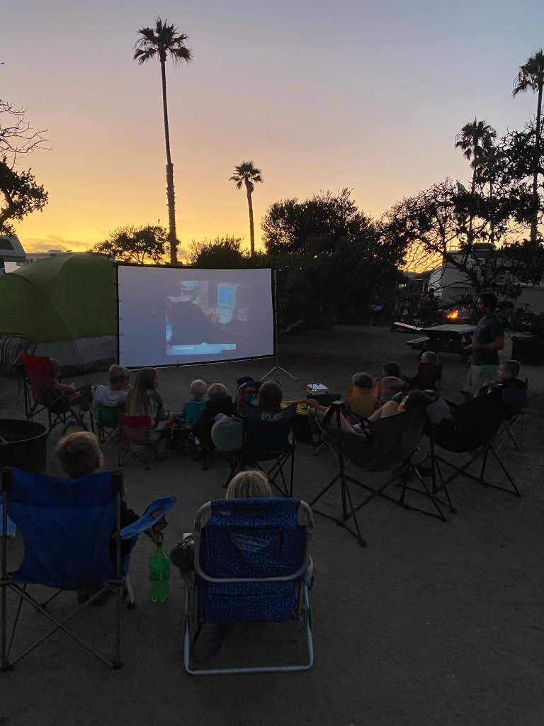 Having an outdoor movie night while camping