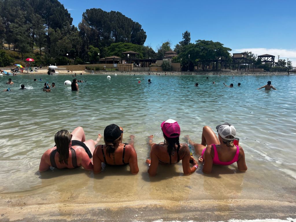 Four women sitting in the pool at one of the campgrounds with a water park in Southern California