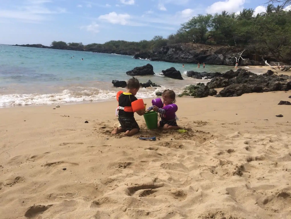 Playing in the sand at one of the beaches of Hawaii Big Island