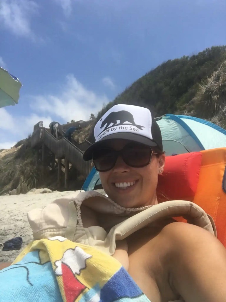 A sleeping baby while camping at the beach