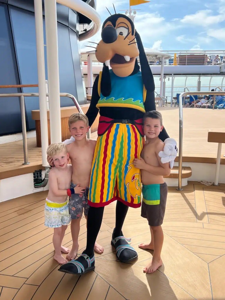Enjoying a Disney cruise and posing with Goofy