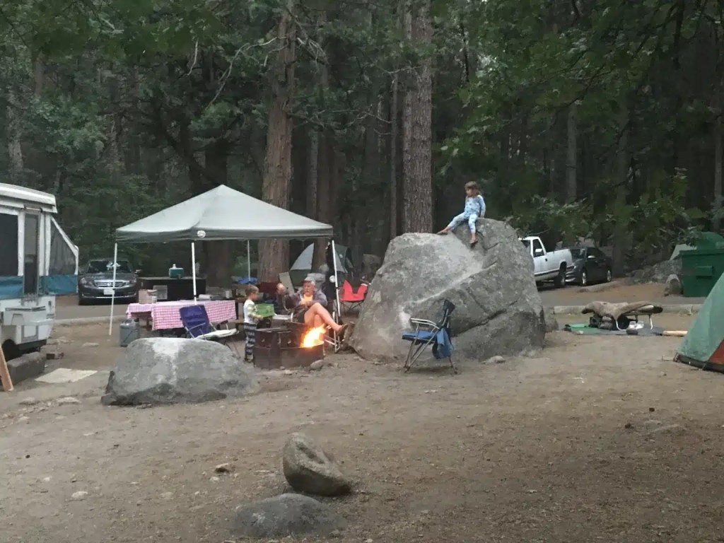 A campfire with a family around it in one of the Yosemite Valley campgrounds