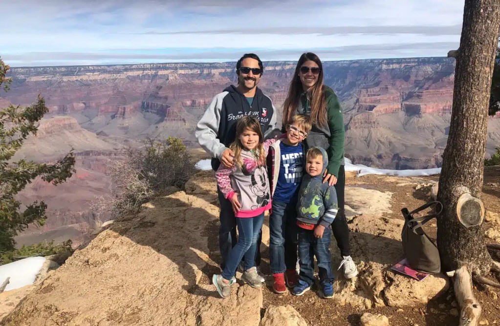 A family posing in front of the Grand Canyon in January