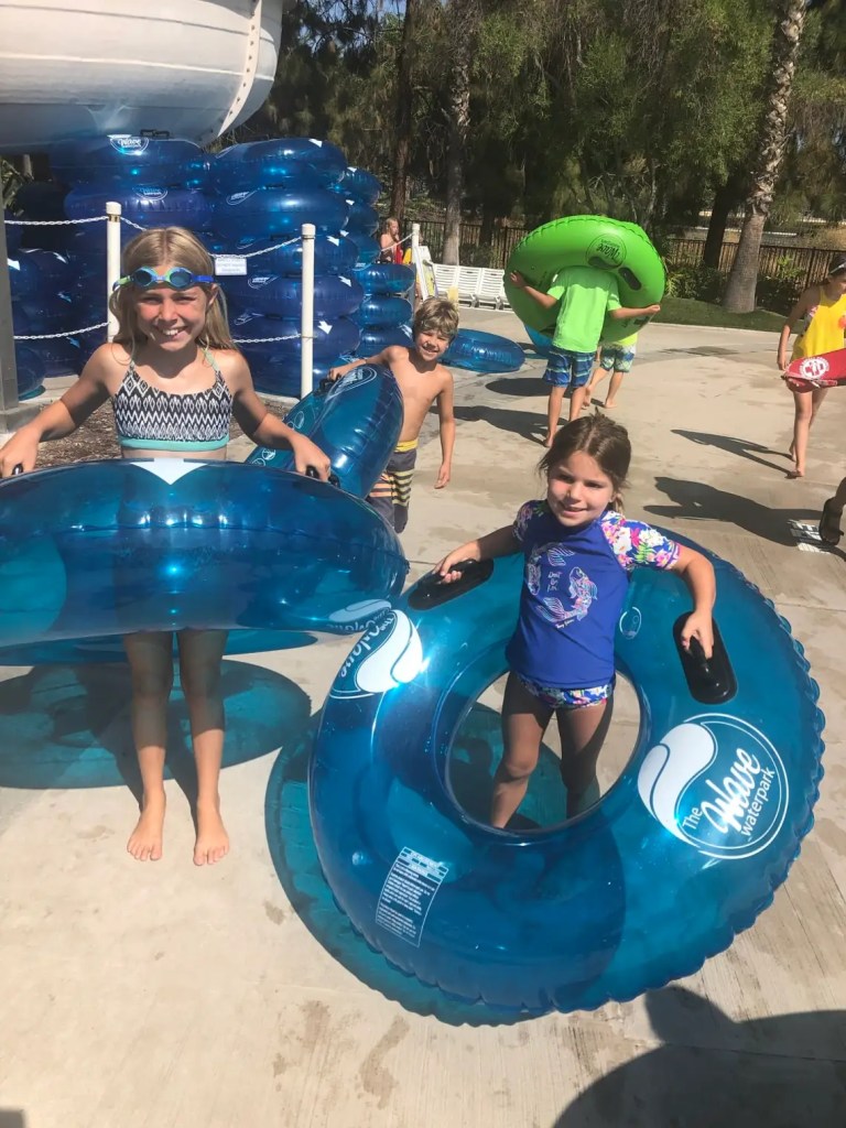 Kids holding inner tubes at one of the water parks in San Diego
