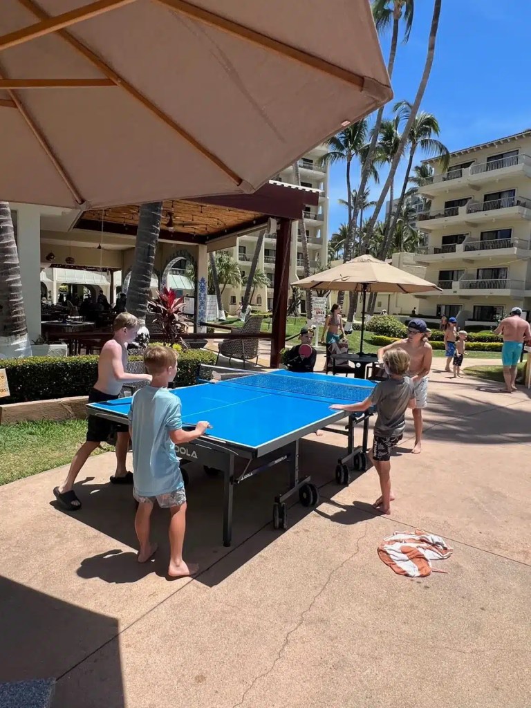 Kids playing ping pong at one of. the cheapest all-inclusive family resorts in Puerto Vallarta