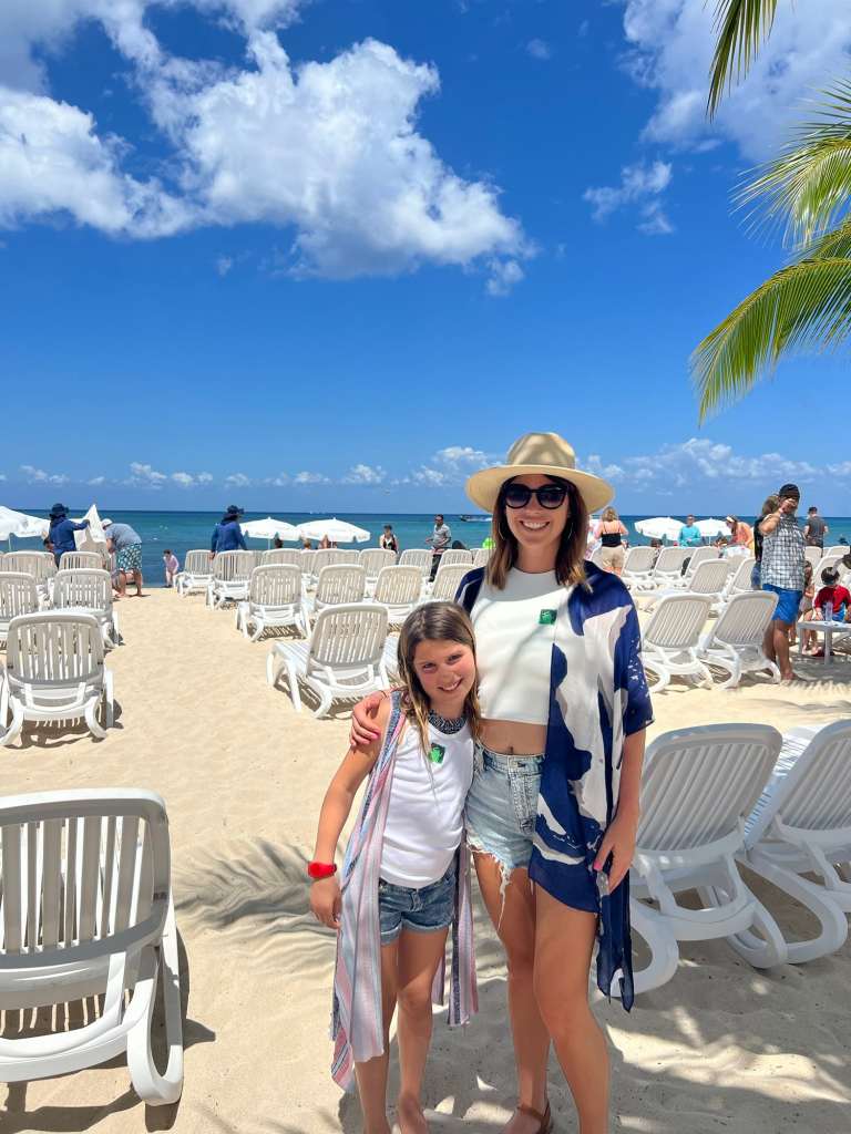 A mom and daughter smiling on a safe beach in Mexico
