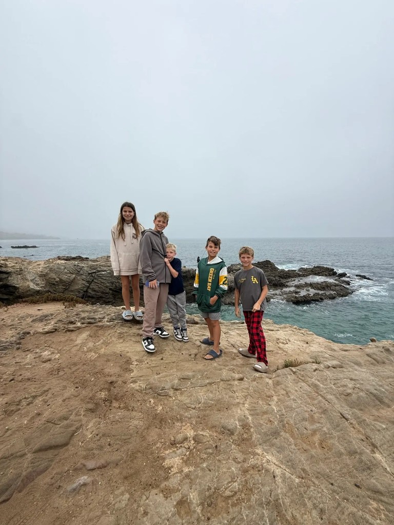 img_3070 Five children standing on a rocky overlook by the ocean on a cloudy day at the Leo Carrillo campground.
