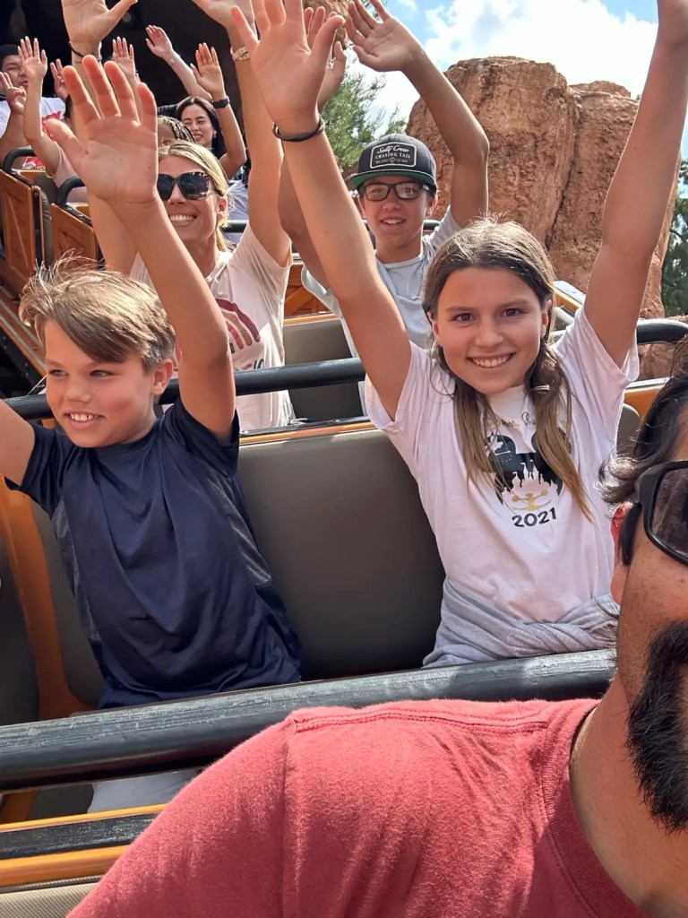 Smiling passengers on a Thunder Mountain train ride at Disneyland