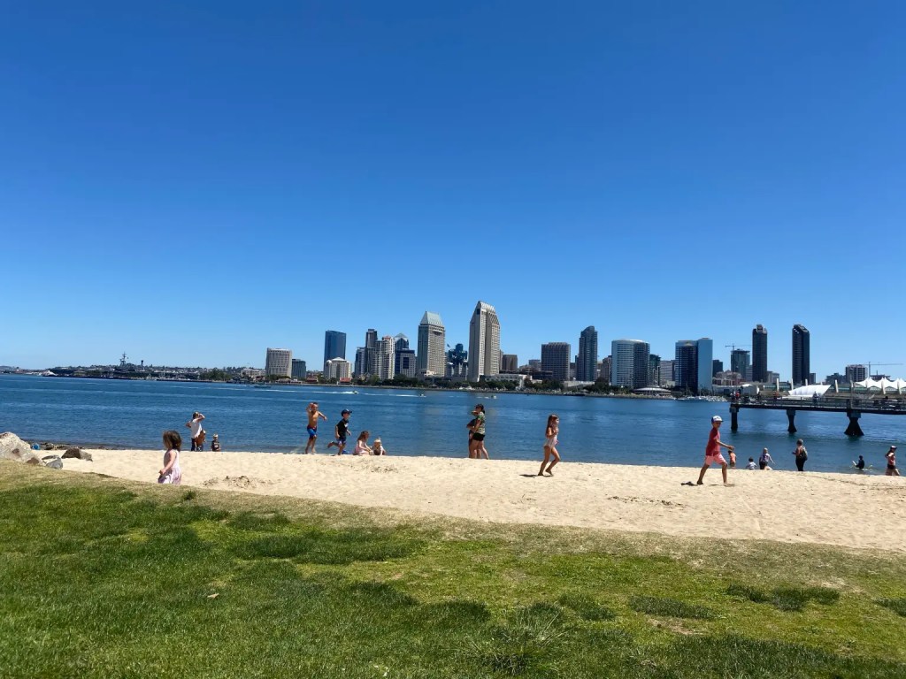 A bay in San Diego with the skyline behind it while on an affordable family vacation