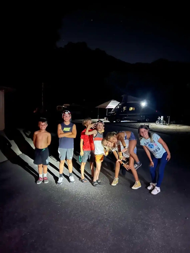 Kids wearing headlamps while camping