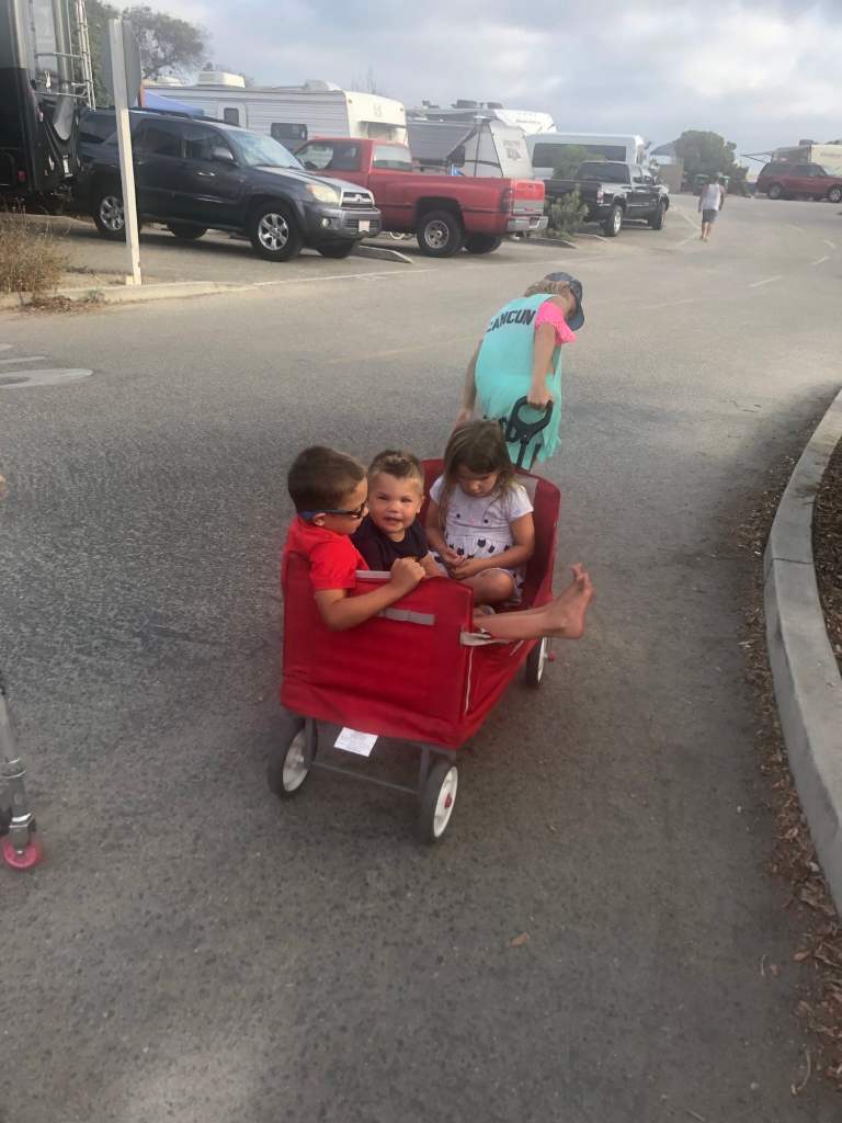 Kids pulling a wagon through the Doheny State Beach Campground