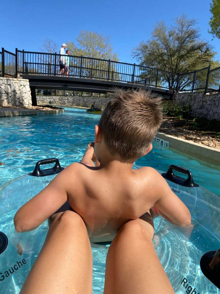 Two people floating down a lazy river at a Texas resort