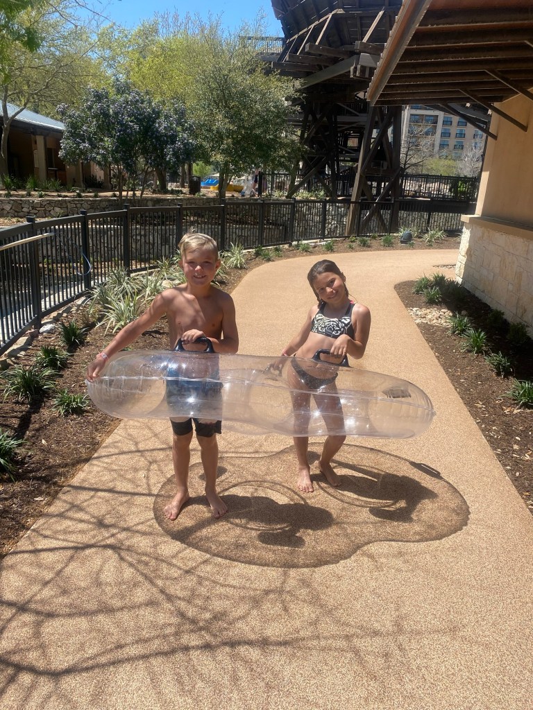 Two kids with an innertube for the lazy river at a Texas resort