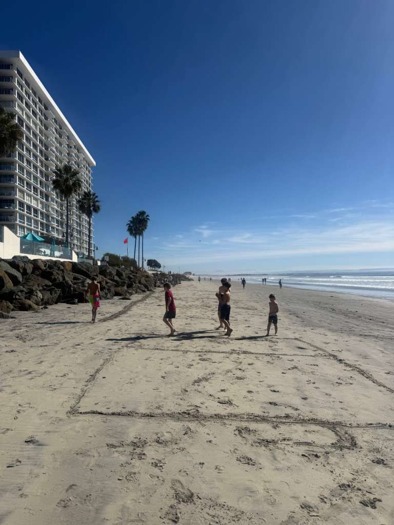 Kids playing football on one of the best beaches of San Diego
