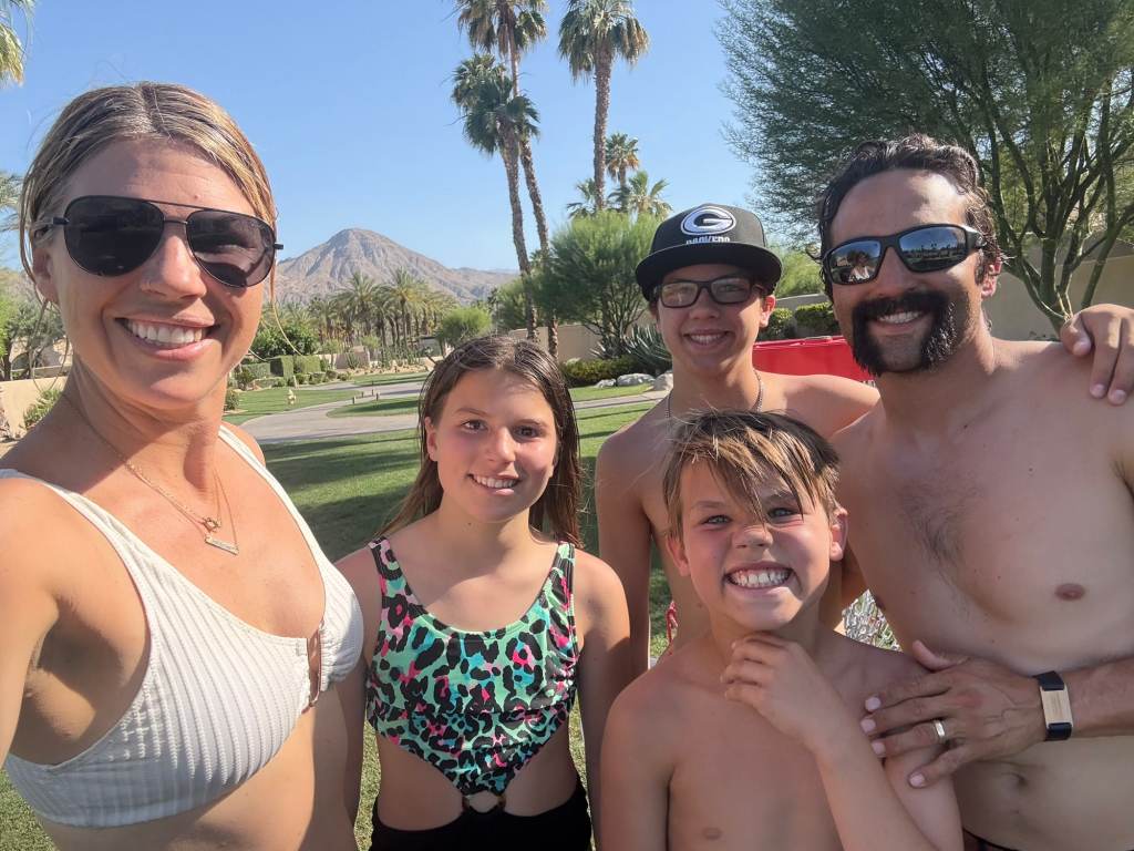 A smiling family of 5 on a Palm Springs vacation in March
