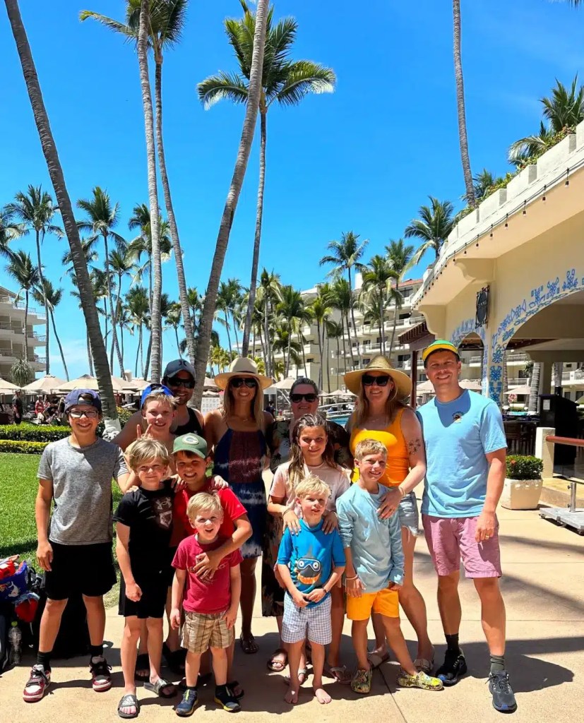 A large family on vacation posing for a picture at an all-inclusive resort in Mexico