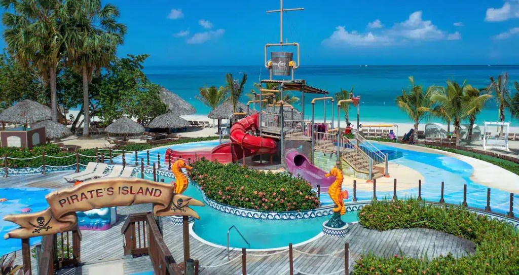 A pool with waterslides right on the beach at one of the best family beach resorts in Jamaica